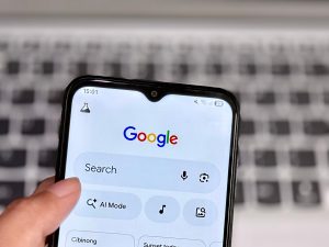 hand holding phone performing google search